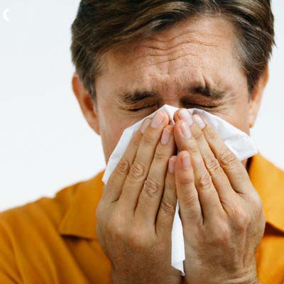 Man Sneezing --- Image by © Sean Justice/Corbis